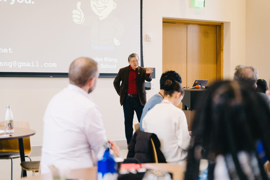 A high school teacher presents to the room.