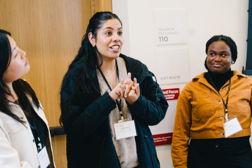 Three graduate students talk.