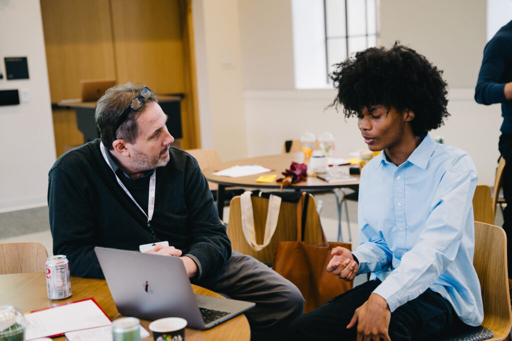 A student and a teacher talk through a topic together.