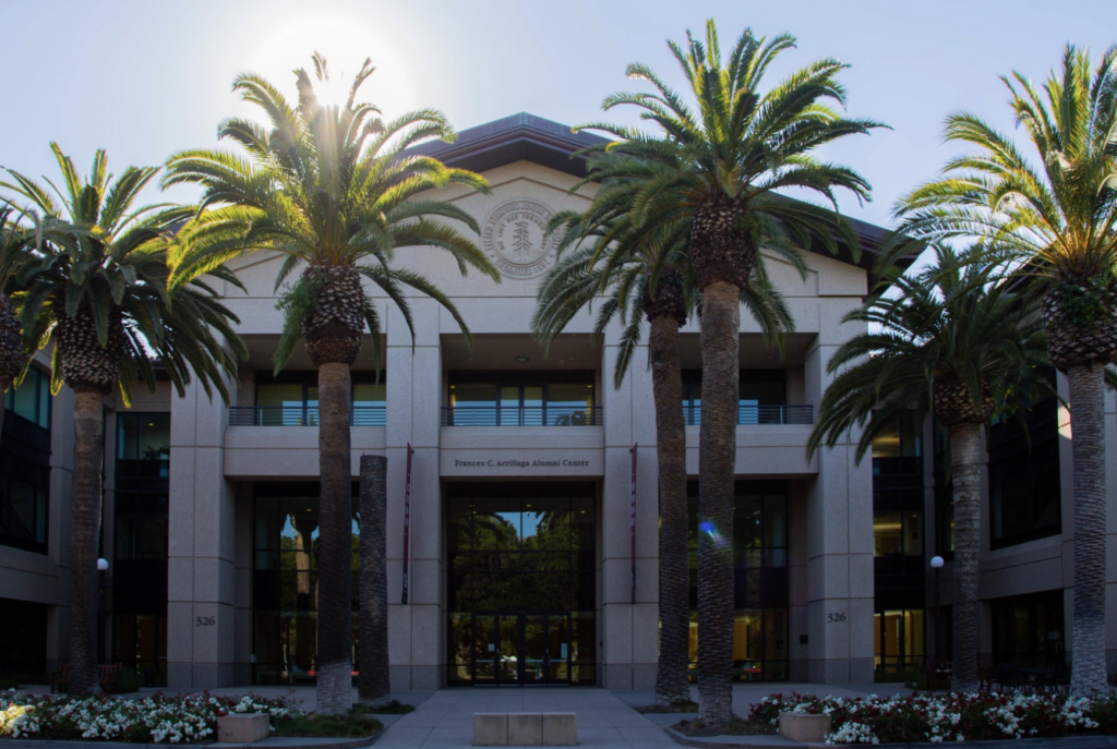 Picture of the Arrillaga Alumni Center with palm trees.