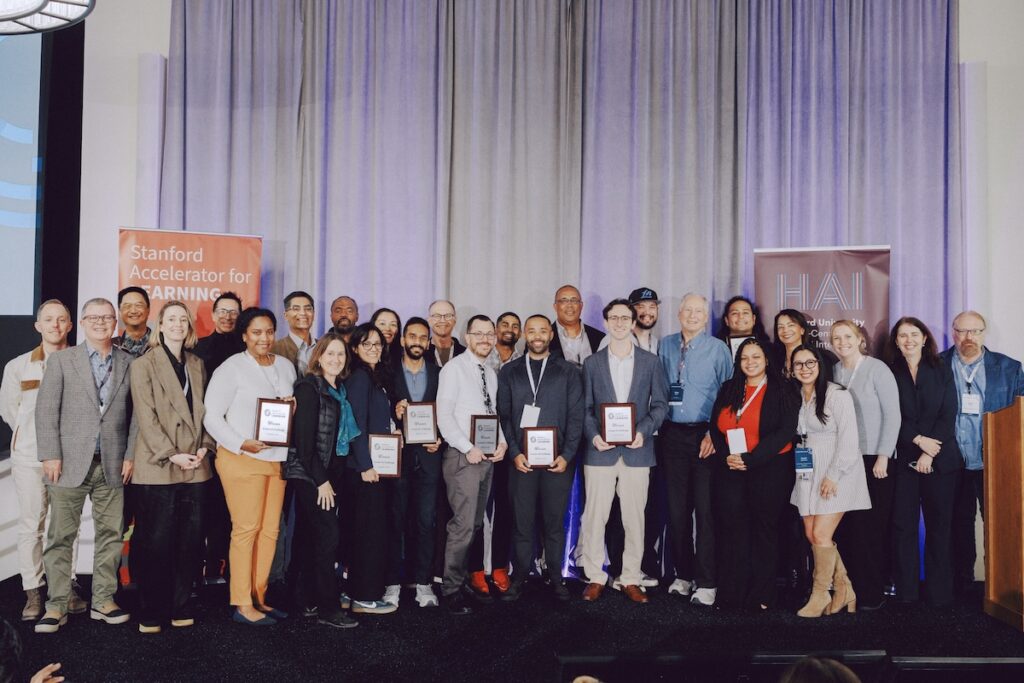 The Create AI challenge winners pose for a photo with judges, reviewers, and event hosts.