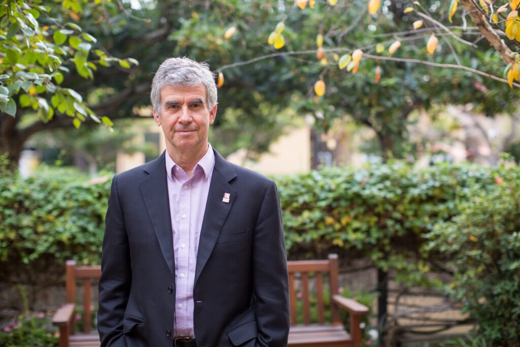 Dan Schwartz stands in a beautiful garden on campus.