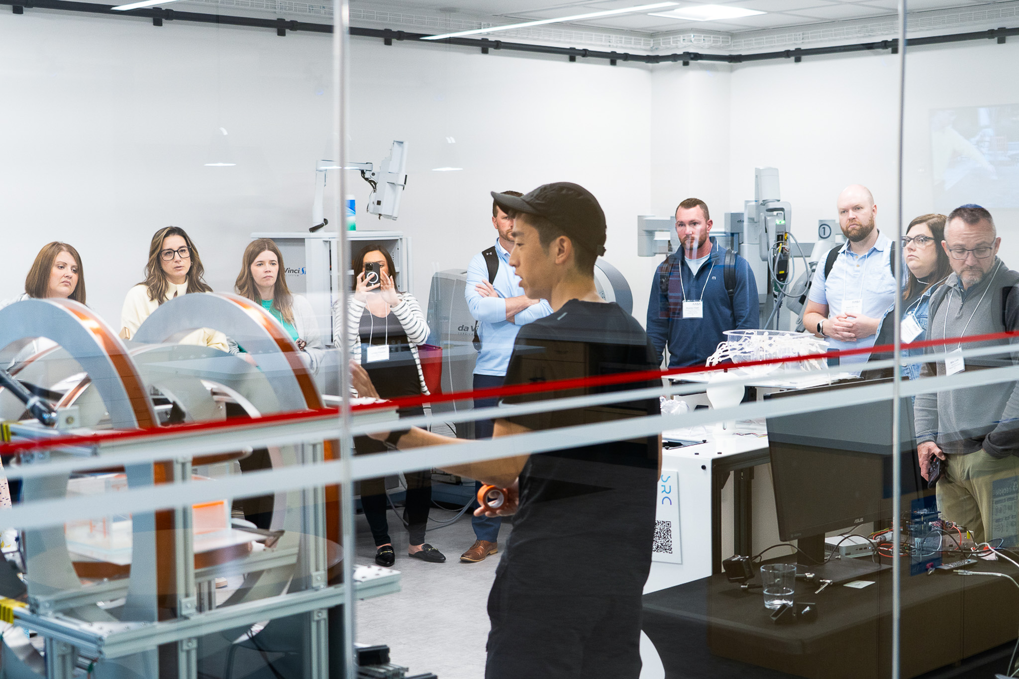 A Stanford researcher gives a group of superintendents a tour of the robotics lab.