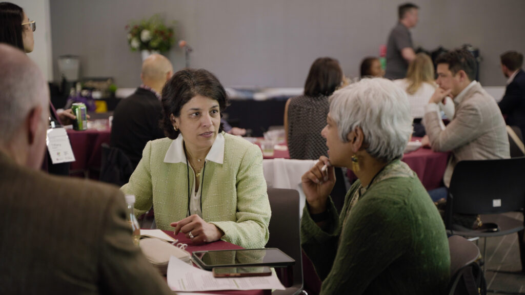 Two attendees chat at an event.