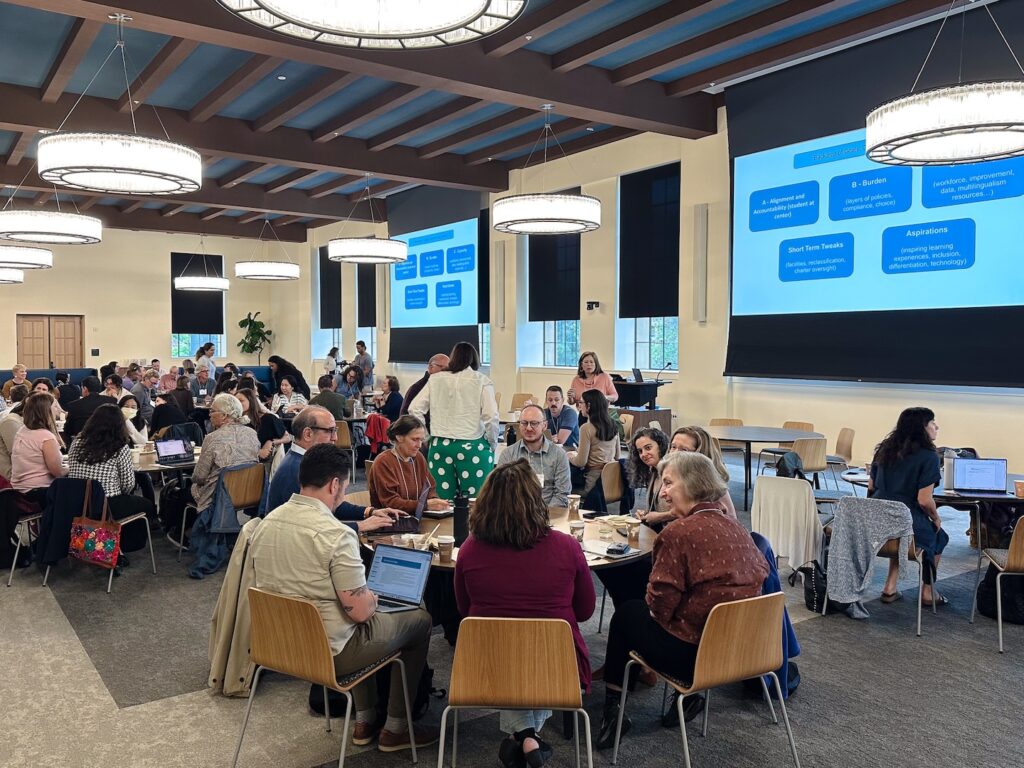 A group of researchers in a large conference room.
